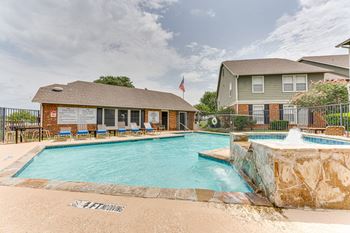 Pool area with stone waterfall and clubhouse
